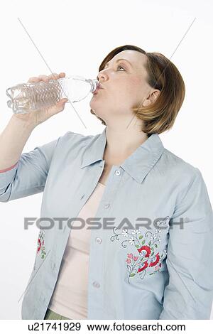 Stock Photo - Mature woman drinking water. Fotosearch