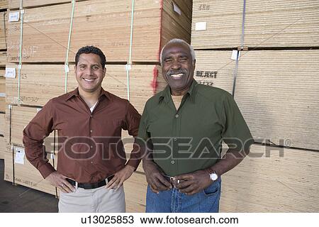 Men in warehouse, portrait View Large Photo Image Stock Image - Men in warehouse, portrait. Fotosearch