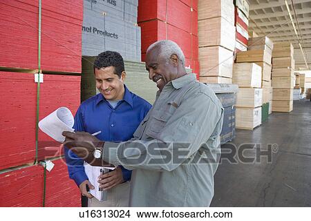 Picture - Men stock-taking in warehouse. Fotosearch