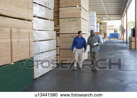 Men stock-taking in warehouse View Large Photo Image Stock Image - Men stock-taking in warehouse. Fotosearch
