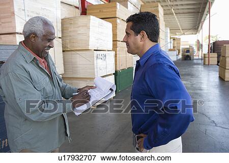 Men stock-taking in warehouse View Large Photo Image Stock Photo - Men stock-taking in warehouse. Fotosearch