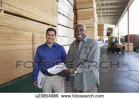 Men with clipboards in front of piles of wood View Large Photo Image Stock Photograph - Men with clipboards in front of piles of wood. Fotosearch