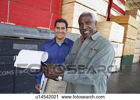 Men with clipboards in front of stacks of wood View Large Photo Image Stock Image - Men with clipboards in front of stacks of wood. Fotosearch