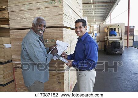 Men with clipboards in front of stacks of wood View Large Photo Image Stock Image - Men with clipboards in front of stacks of wood. Fotosearch