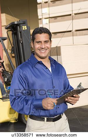 Mid-adult warehouseman View Large Photo Image Stock Image - Mid-adult warehouseman. Fotosearch