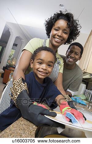 Mother father and son in domestic kitchen, washing dishes View Large Photo Image Stock Photography - Mother father and son in domestic kitchen, washing dishes. Fotosearch