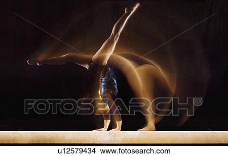 Multiple exposure image of female gymnast in motion on balance beam View Large Photo Image Picture - Multiple exposure image of female gymnast in motion on balance beam. Fotosearch