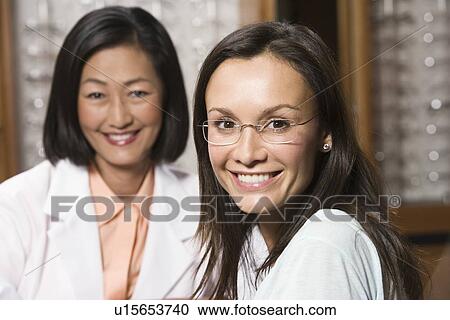 Optician with customer in store View Large Photo Image Stock Image - Optician with customer in store. Fotosearch