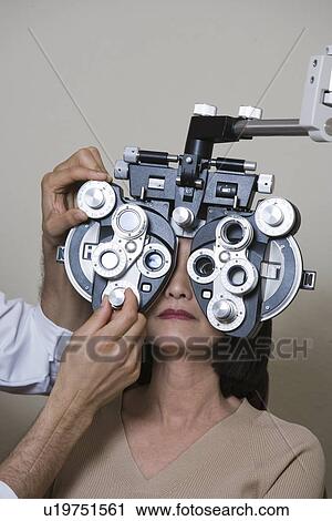 Optometrist examining patient's eyes View Large Photo Image Stock Image - Optometrist examining patient's eyes. Fotosearch
