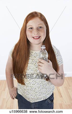 Overweight Girl (13-15) smiling, holding bottle, portrait View Large Photo Image Stock Photo - Overweight Girl (13-15) smiling, holding bottle, portrait. Fotosearch