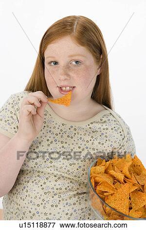 Overweight girl eating potato chips View Large Photo Image Stock Photo - Overweight girl eating potato chips. Fotosearch