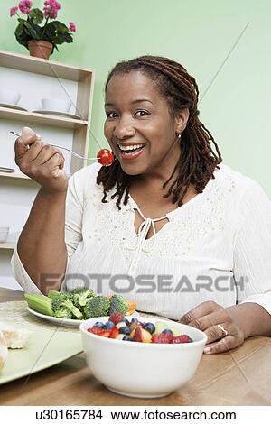 Overweight woman eating healthy food, portrait View Large Photo Image Picture - Overweight woman eating healthy food, portrait. Fotosearch