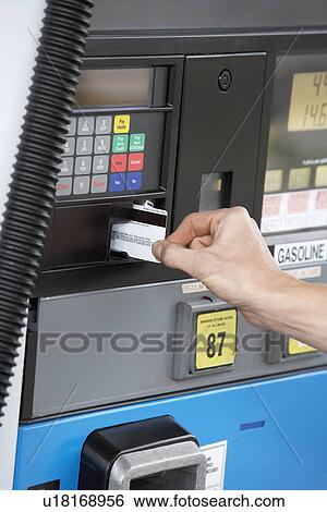 Person paying with credit card at gas pump, close up of hand View Large Photo Image Stock Photograph - Person paying with credit card at gas pump, close up of hand. Fotosearch