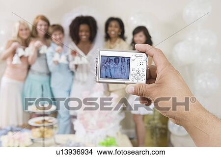 Person photographing women at bridal shower View Large Photo Image Picture - Person photographing women at bridal shower. Fotosearch