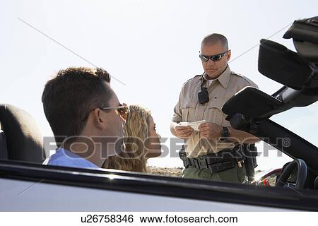 Police officer issuing ticket to couple in car View Large Photo Image Stock Photograph - Police officer issuing ticket to couple in car. Fotosearch