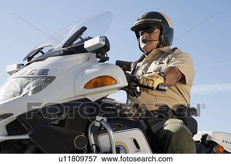 Police officer riding on motorcycle View Large Photo Image Stock Photo - Police officer riding on motorcycle. Fotosearch