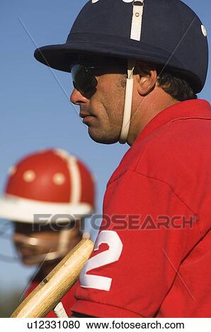 Stock Image - Polo player wearing helmet. Fotosearch
