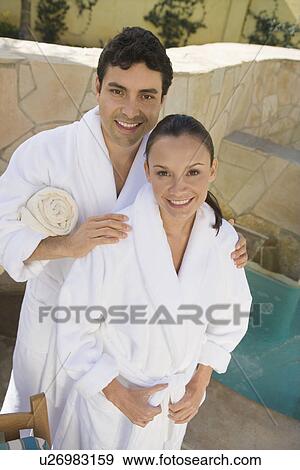 Stock Photo - Portrait of couple in bathrobes, outdoors. Fotosearch