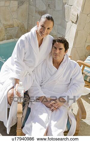 Portrait of couple relaxing by swimming pool View Large Photo Image Stock Photograph - Portrait of couple relaxing by swimming pool. Fotosearch
