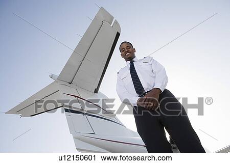 Portrait of flight attendant standing in front of private jet. View Large Photo Image Stock Image - Portrait of flight attendant standing in front of private jet.. Fotosearch