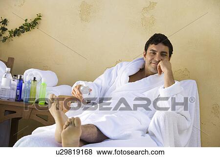 Stock Photo - Portrait of man in bathrobe, relaxing outdoors. Fotosearch