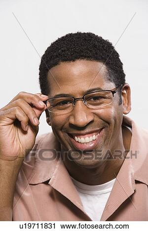 Stock Image - Portrait of man wearing eyeglasses. Fotosearch