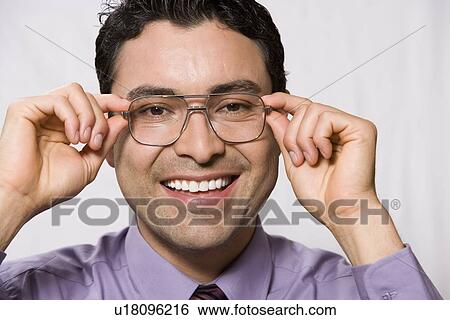Stock Photograph - Portrait of man wearing eyeglasses. Fotosearch