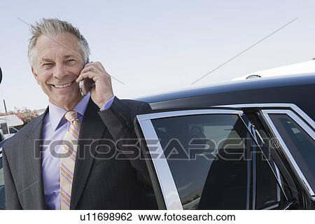 Portrait of senior businessman standing in front of limousine and talking on phone. View Large Photo Image Stock Image - Portrait of senior businessman standing in front of limousine and talking on phone.. Fotosearch