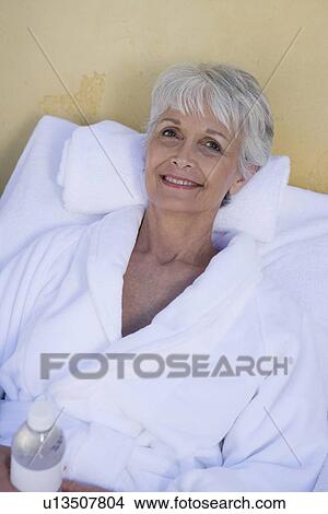 Picture - Portrait of senior woman in bathrobe at health spa. Fotosearch