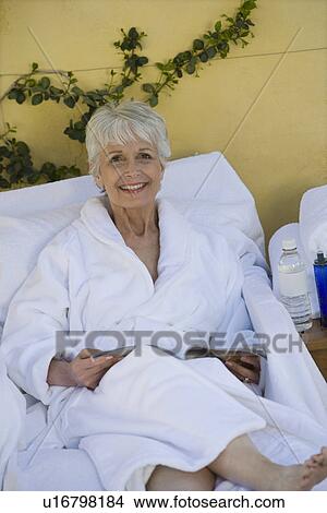 Picture - Portrait of senior woman in bathrobe at health spa. Fotosearch