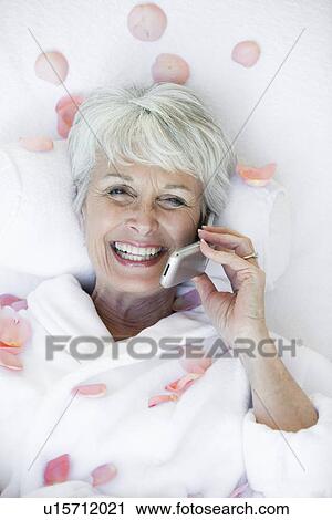 Portrait of senior woman using mobile phone View Large Photo Image Stock Image - Portrait of senior woman using mobile phone. Fotosearch