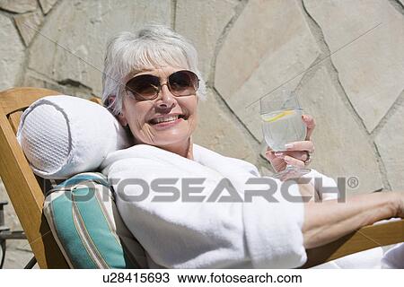 Portrait of senior woman with drink View Large Photo Image Stock Image - Portrait of senior woman with drink. Fotosearch