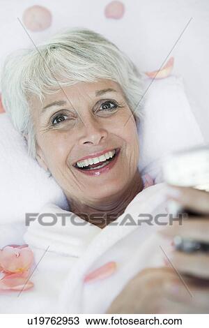 Portrait of senior woman with petals View Large Photo Image Stock Image - Portrait of senior woman with petals. Fotosearch