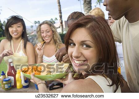Portrait of Teenage Girl (18-19) at Party, Others in Background View Large Photo Image Stock Photo - Portrait of Teenage Girl (18-19) at Party, Others in Background. Fotosearch