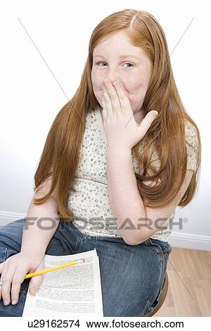 Portrait of teenage girl laughing, covering mouth View Large Photo Image Picture - Portrait of teenage girl laughing, covering mouth. Fotosearch