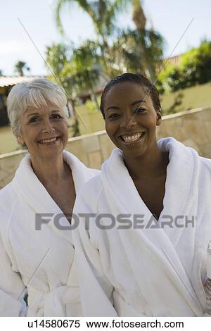 Stock Photography - Portrait of two women in bathrobes at health spa. Fotosearch
