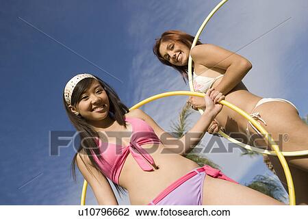 Stock Image - Portrait of Two Women with Hula Hoops. Fotosearch