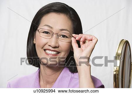 Portrait of woman wearing eyeglasses View Large Photo Image Picture - Portrait of woman wearing eyeglasses. Fotosearch