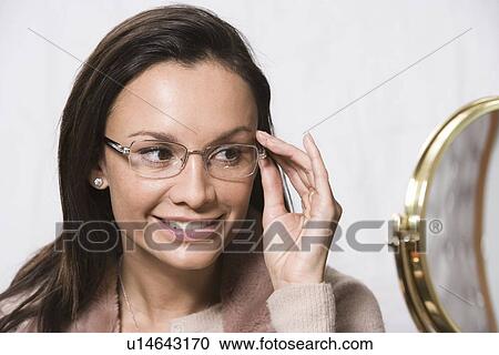 Stock Image - Portrait of woman wearing eyeglasses. Fotosearch