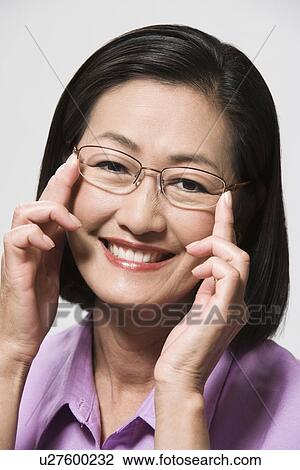 Stock Image - Portrait of woman wearing eyeglasses. Fotosearch