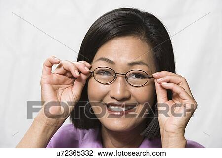 Portrait of woman wearing eyeglasses View Large Photo Image Stock Image - Portrait of woman wearing eyeglasses. Fotosearch