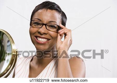 Stock Photo - Portrait of woman wearing eyeglasses. Fotosearch