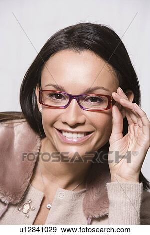 Stock Photo - Portrait of woman wearing eyeglasses. Fotosearch