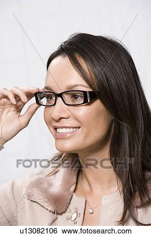Stock Photograph - Portrait of woman wearing eyeglasses. Fotosearch