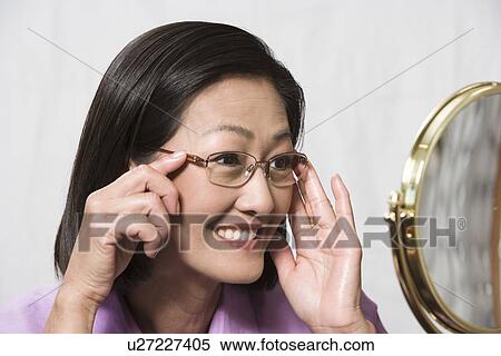 Portrait of woman wearing eyeglasses View Large Photo Image Stock Photography - Portrait of woman wearing eyeglasses. Fotosearch