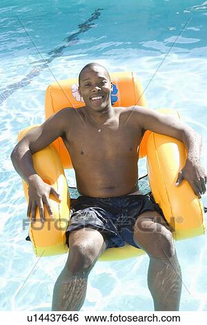 Portrait of Young Man on Inflatable Chair View Large Photo Image Stock Photograph - Portrait of Young Man on Inflatable Chair. Fotosearch