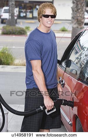 Portrait of young man with fuel pump View Large Photo Image Stock Image - Portrait of young man with fuel pump. Fotosearch