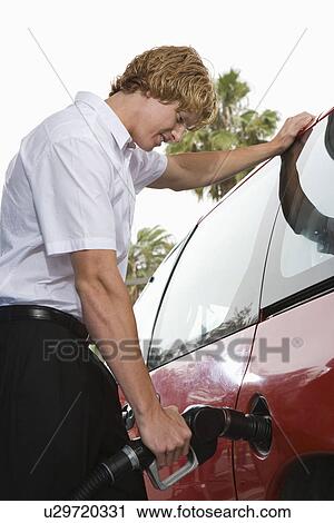 Portrait of young man with fuel pump View Large Photo Image Stock Image - Portrait of young man with fuel pump. Fotosearch