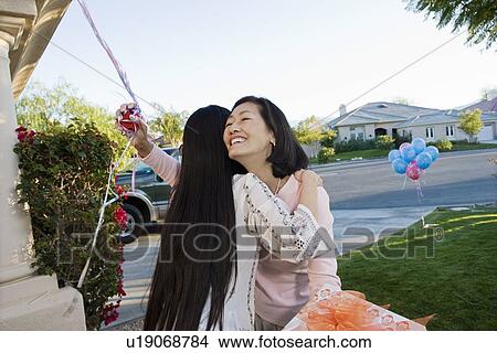 Pregnant Asian Woman embracing Mother at a Baby Shower View Large Photo Image Picture - Pregnant Asian Woman embracing Mother at a Baby Shower. Fotosearch