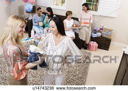 Stock Photo - Pregnant Asian Woman with friend at a Baby Shower. Fotosearch